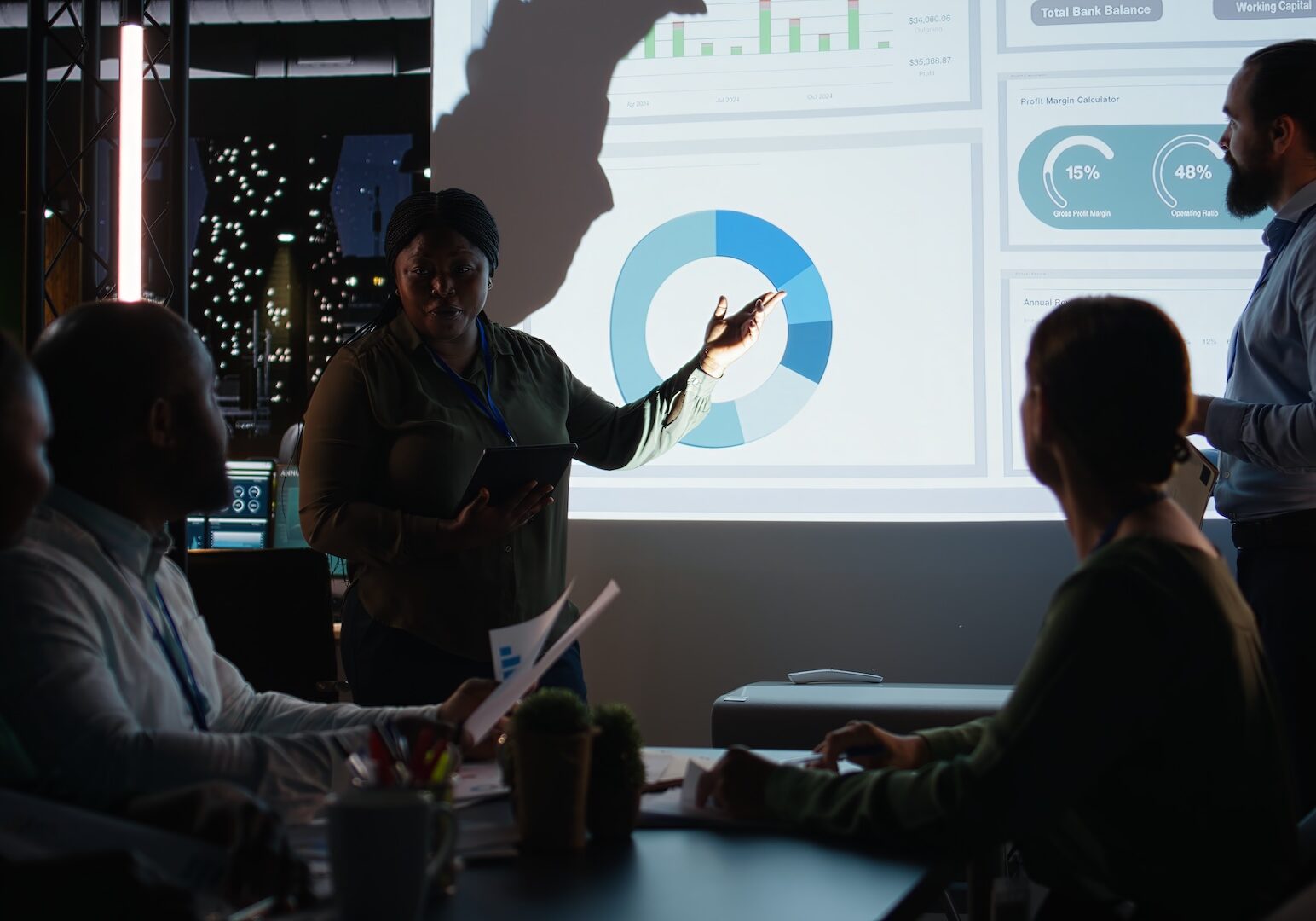 Advisor standing at table in front of presentation